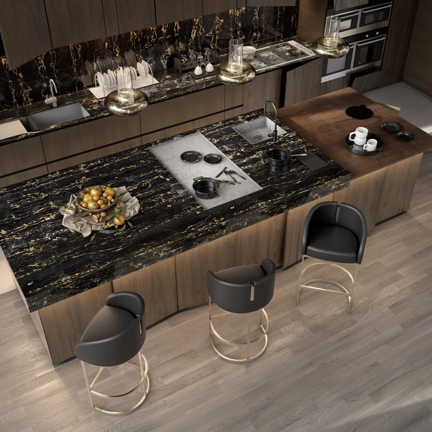 Overhead view of kitchen counter with dark marble countertop and gold and dark leather stools.